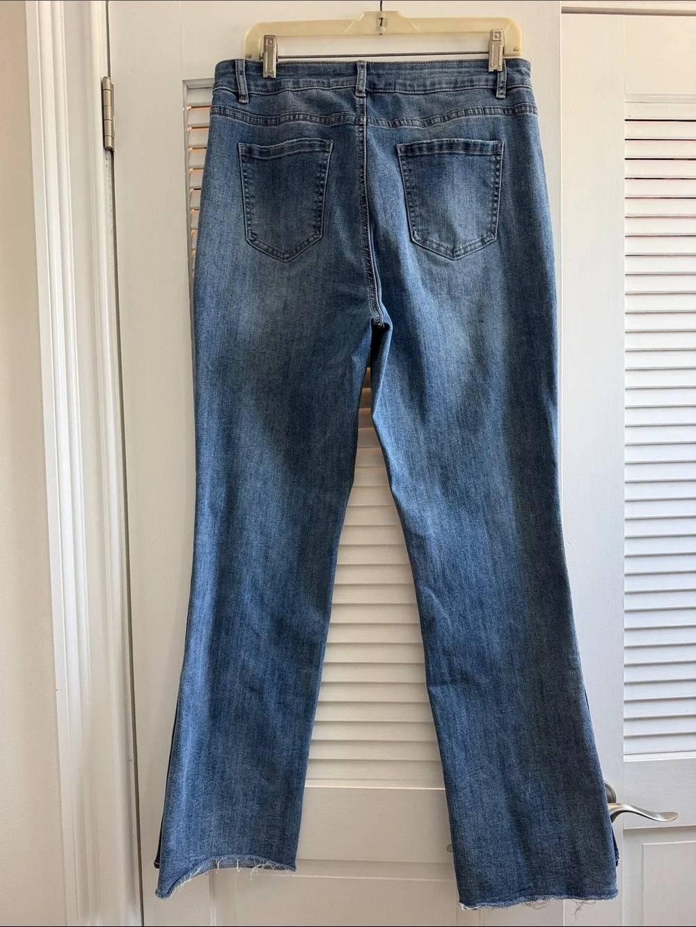 Charlie B Light Wash Button-Hem Straight Jeans with hem button detail.